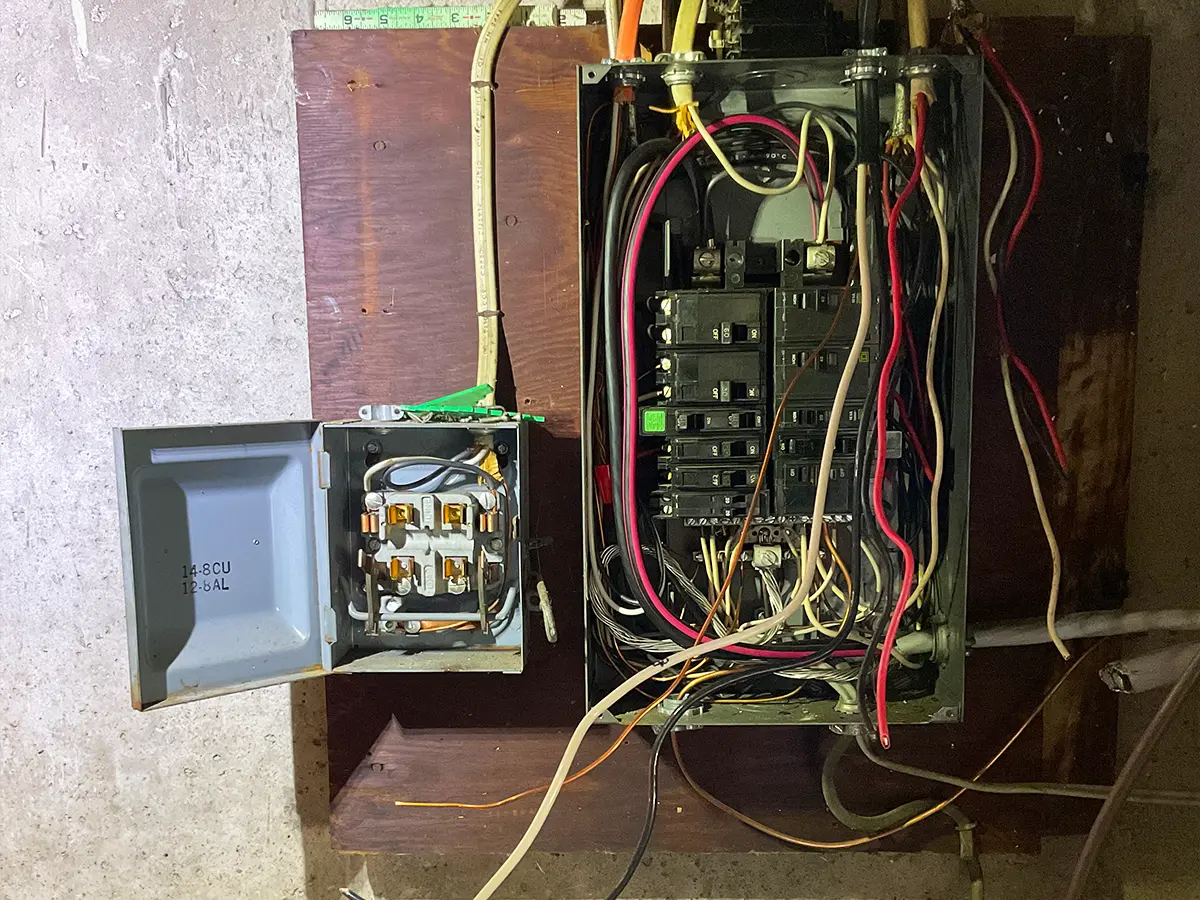 Residential electrical box with open wiring and breakers for panel upgrade.